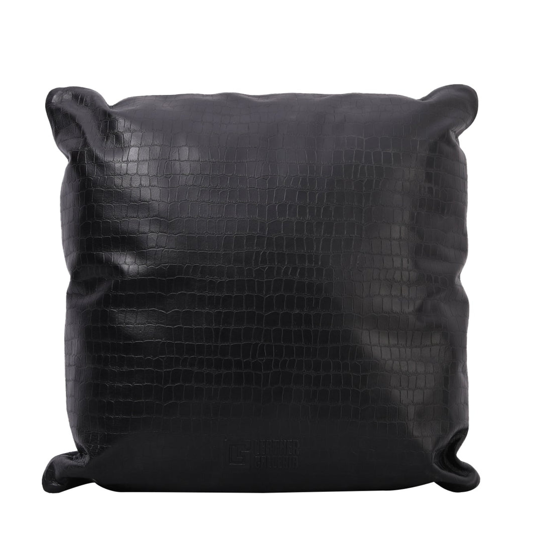 Black leather pillow with crocodile texture on a white background

