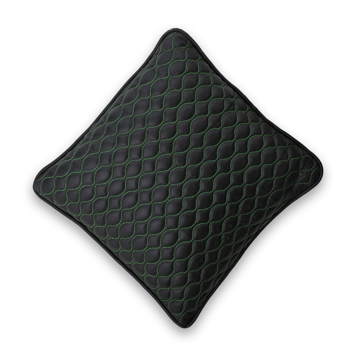 Black textured pillow with green stitching on a white background

