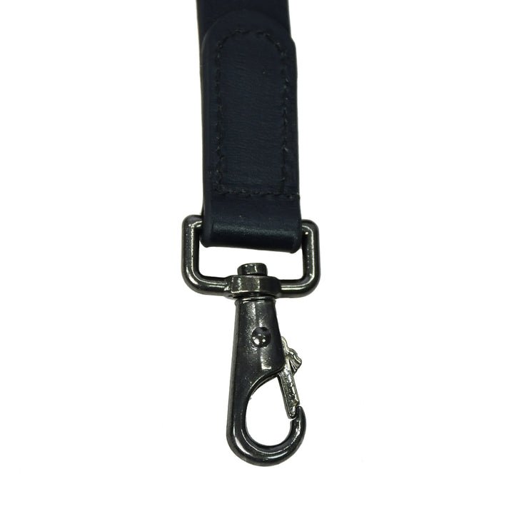 Black strap with metal clasp on a white background

