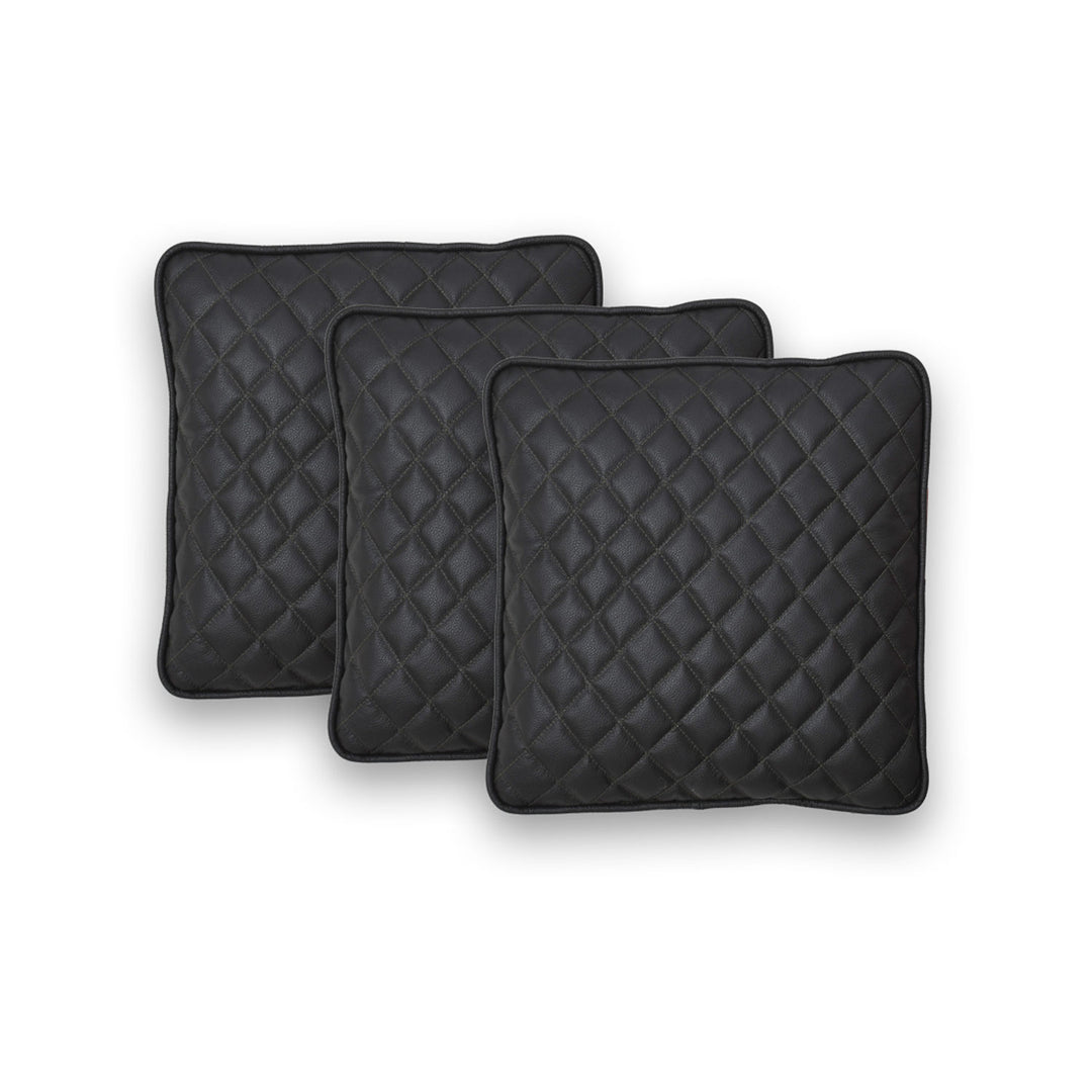 Three black quilted square cushions on a white background