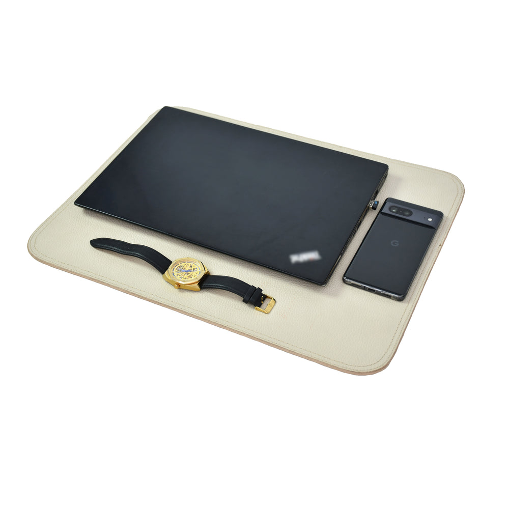 White leather table mat with white contrast stitching on a white background.