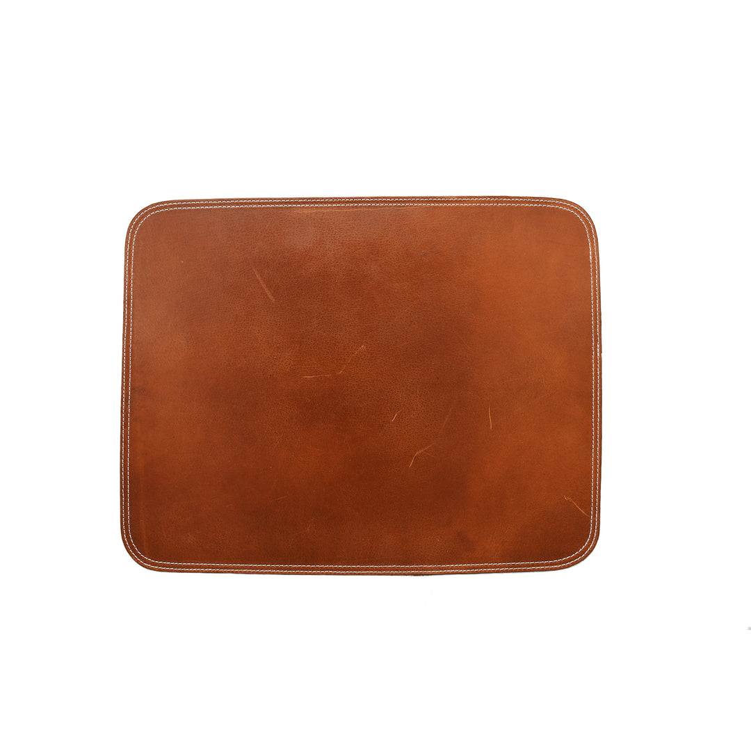 Close-up of a brown leather Mat with white contrast stitching on a white background.