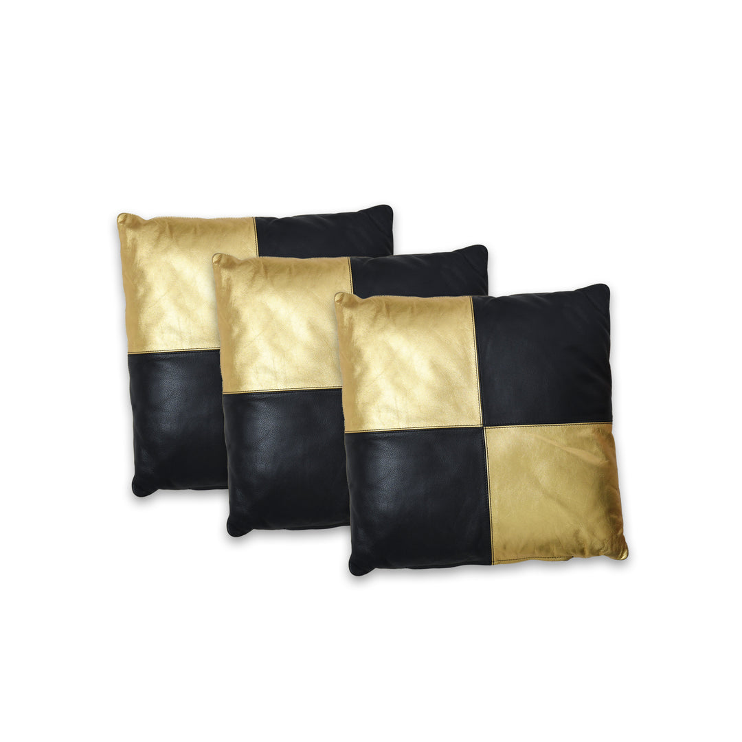 Three black and gold checkered pillows on a white background

