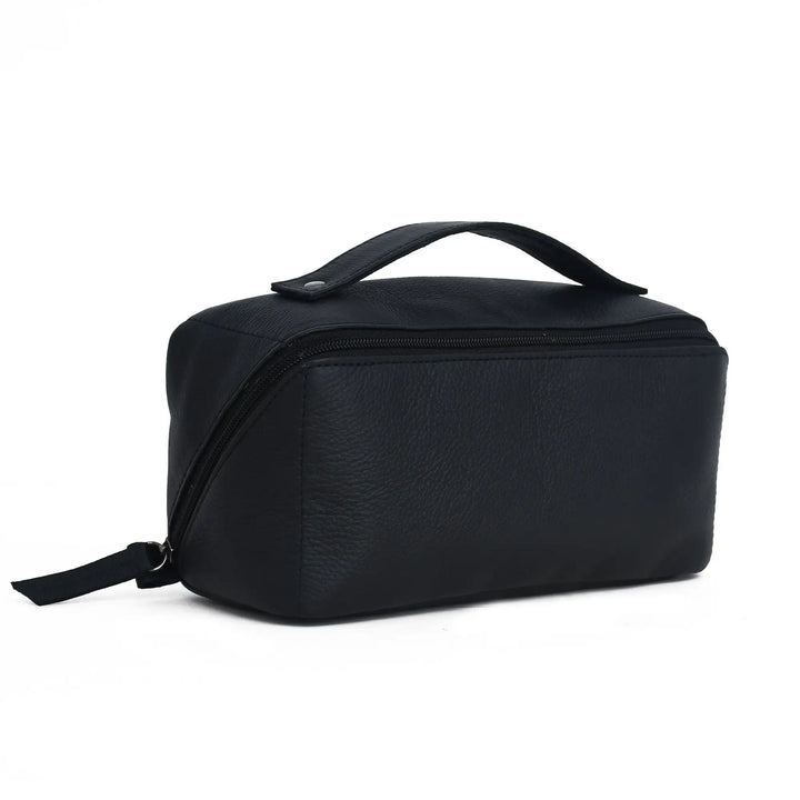 A black pebbled faux-leather cosmetic bag with a top handle and zippered closure, shown from a three-quarters angle on a white background.