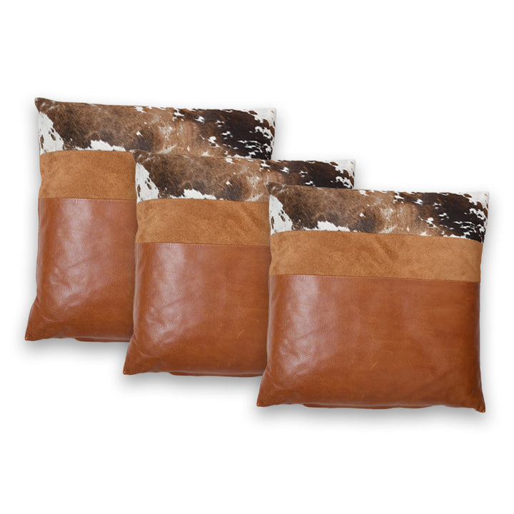 Two brown leather pillows with cowhide pattern on a white background

