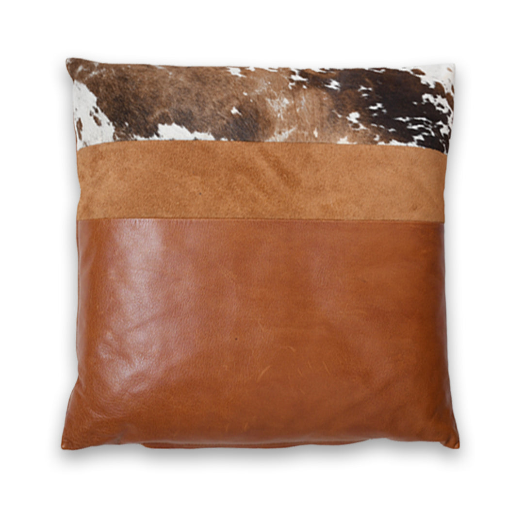 Pillow with cowhide top and brown leather bottom on a white background

