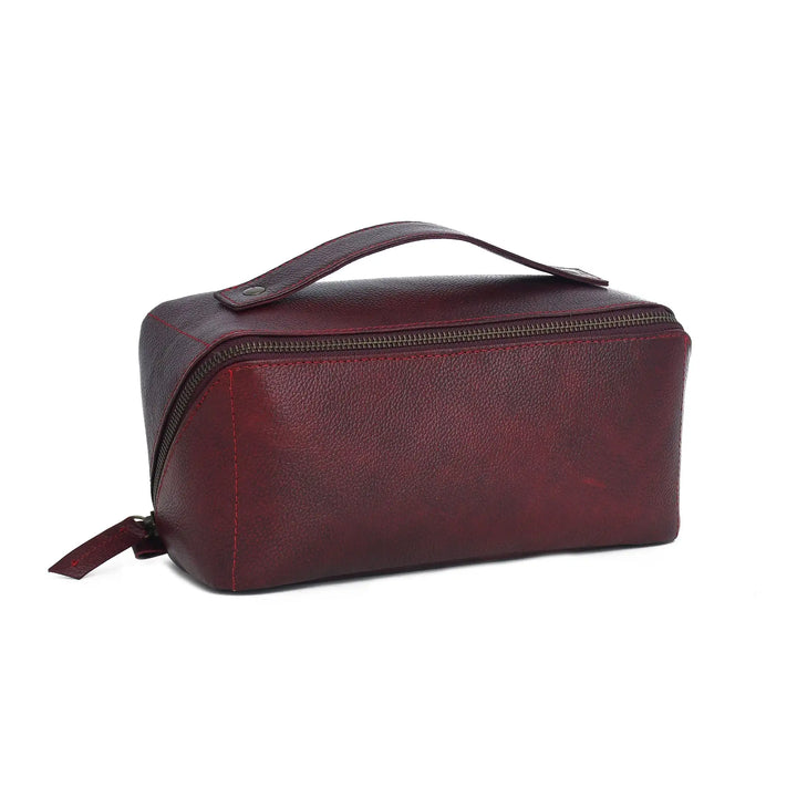 Burgundy leather toiletry bag on a white background