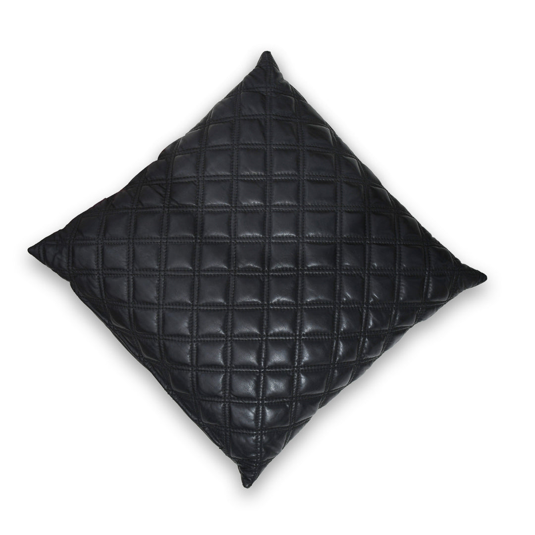 Black quilted pillow on a white background


