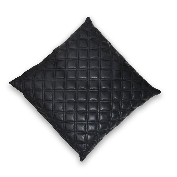 Black quilted pillow on a white background

