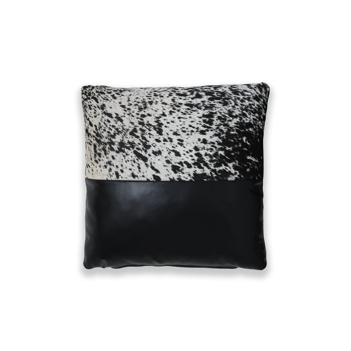 Pillow with black and white cowhide pattern on a white background