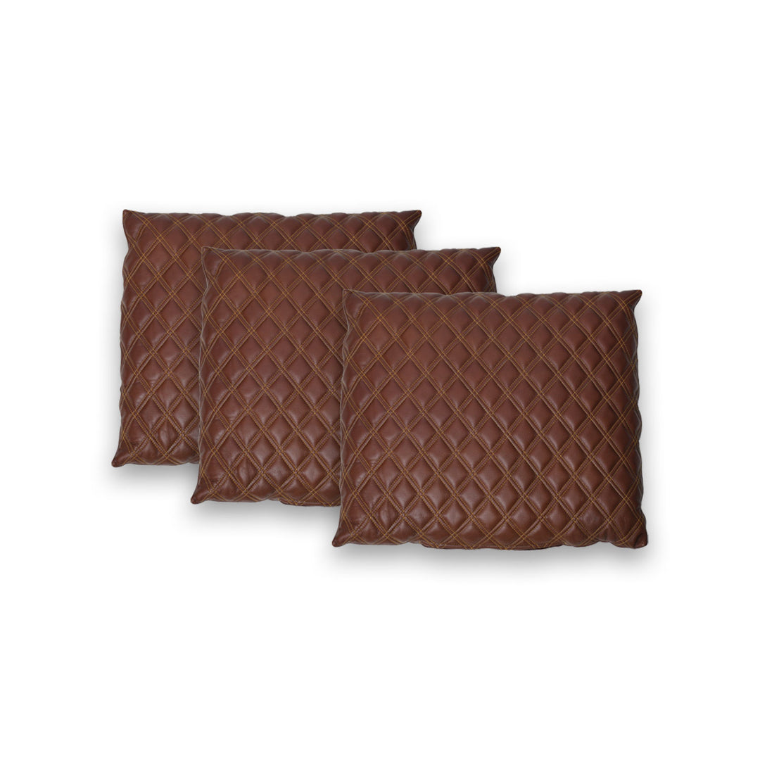 Three brown quilted pillows on a white background

