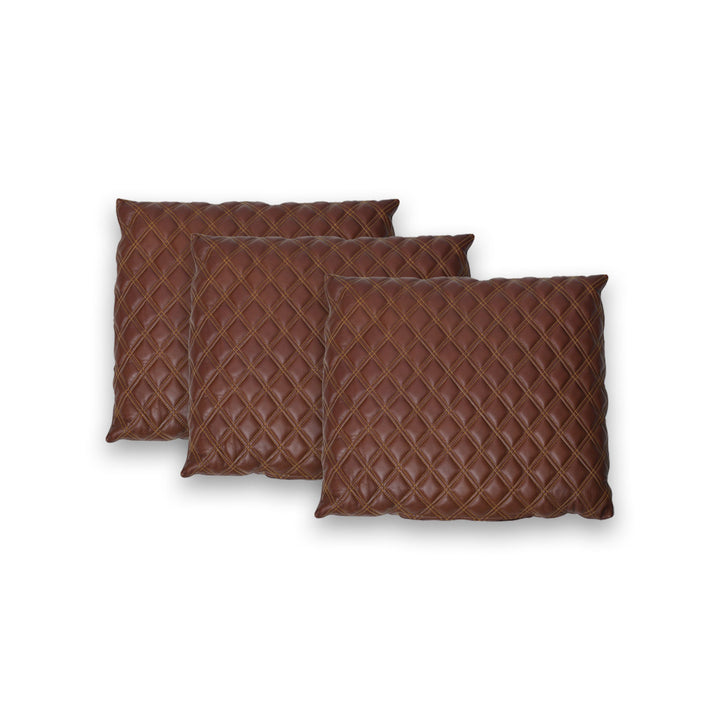 Three brown quilted pillows on a white background

