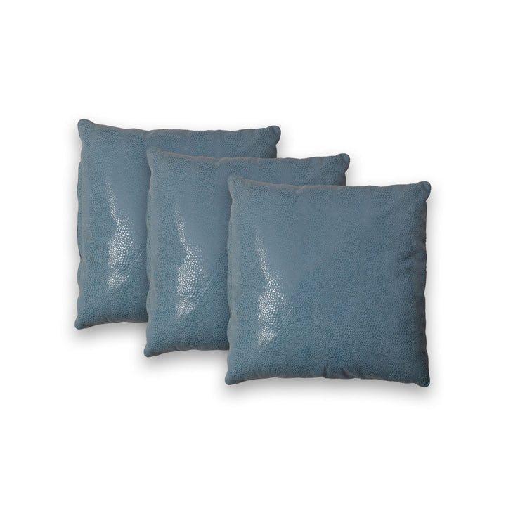 Three blue textured pillows on a white background

