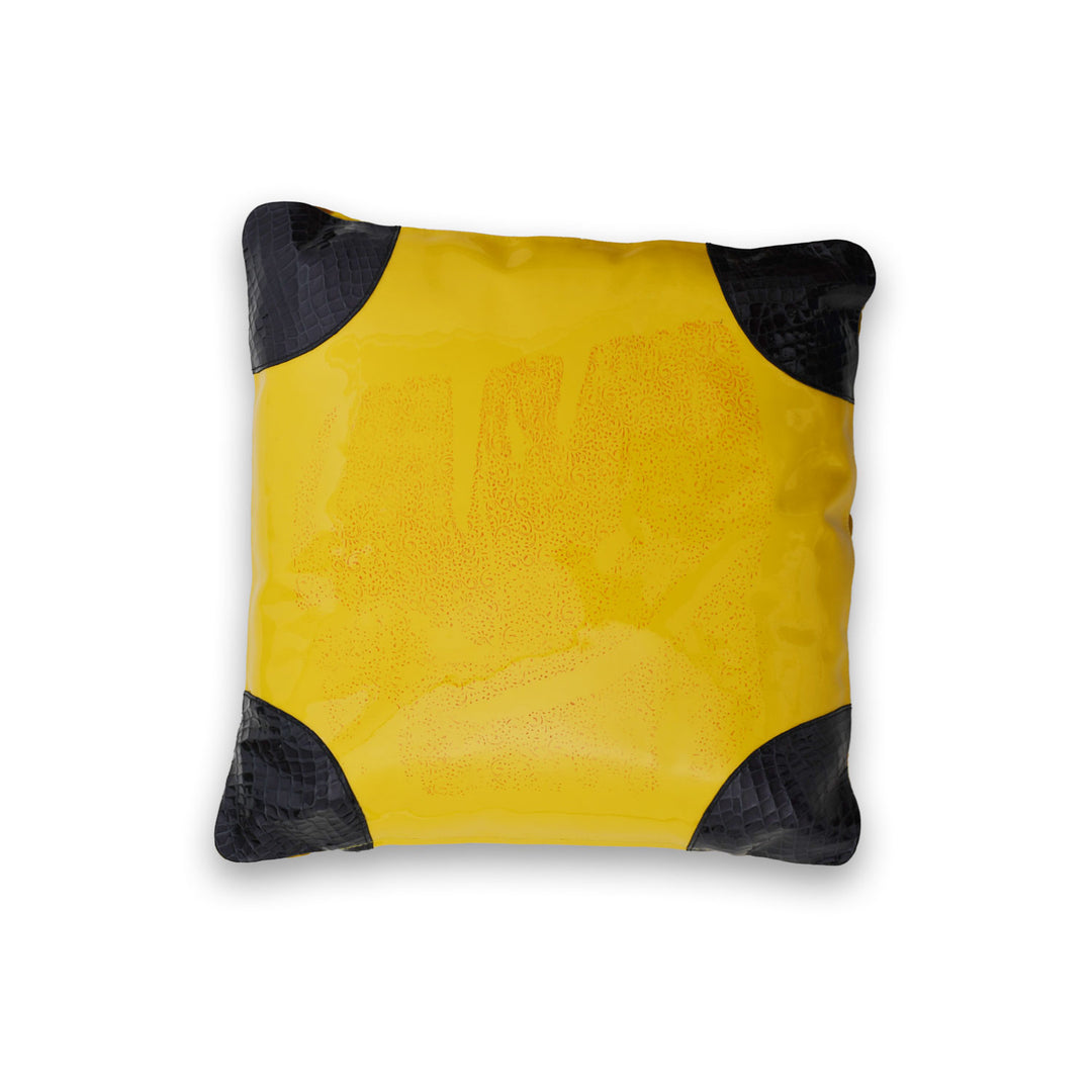 Yellow pillow with black accents on a white background

