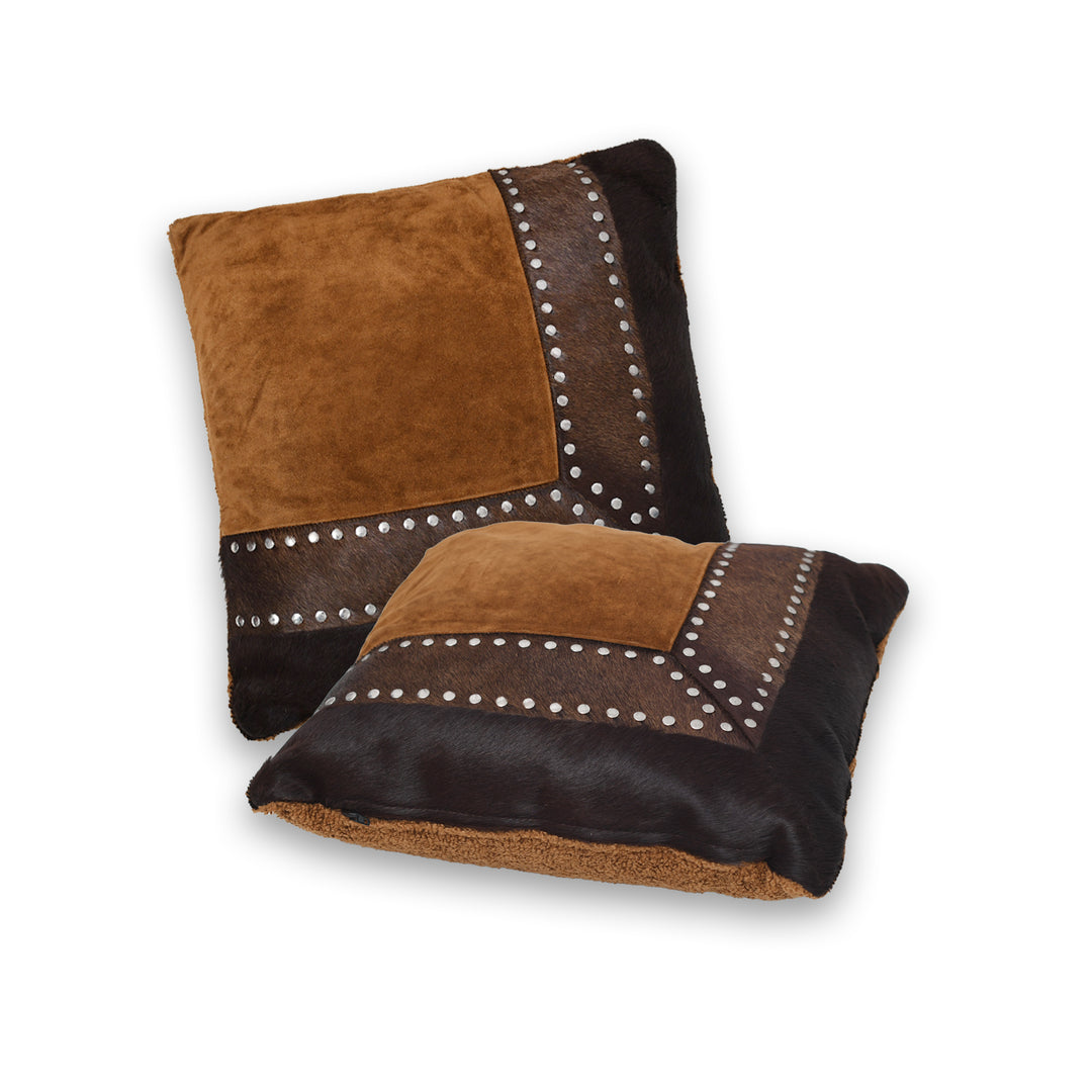 Brown and black cushion with studded details on a white background

