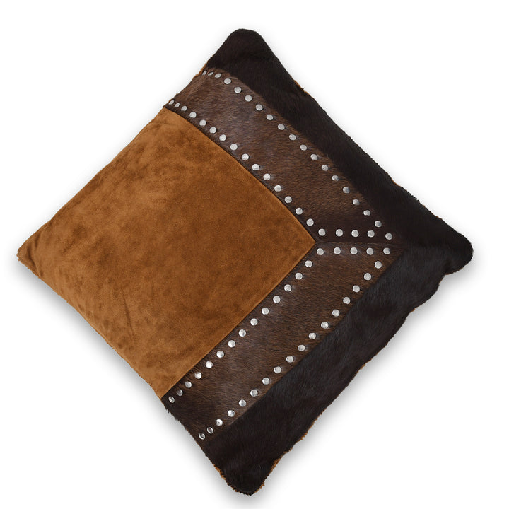 Decorative cushion with brown and black leather and studded details on a white background


