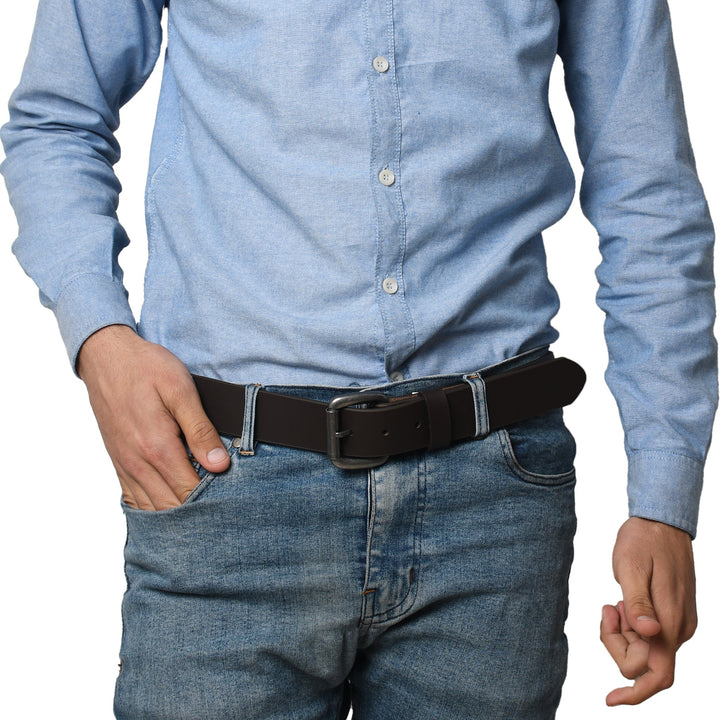 Person wearing a light blue button-up shirt and dark jeans with a black belt.