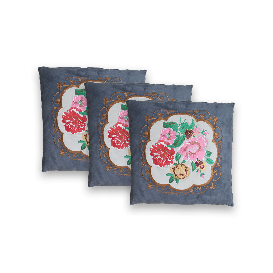 Three decorative pillows with floral patterns on a white background