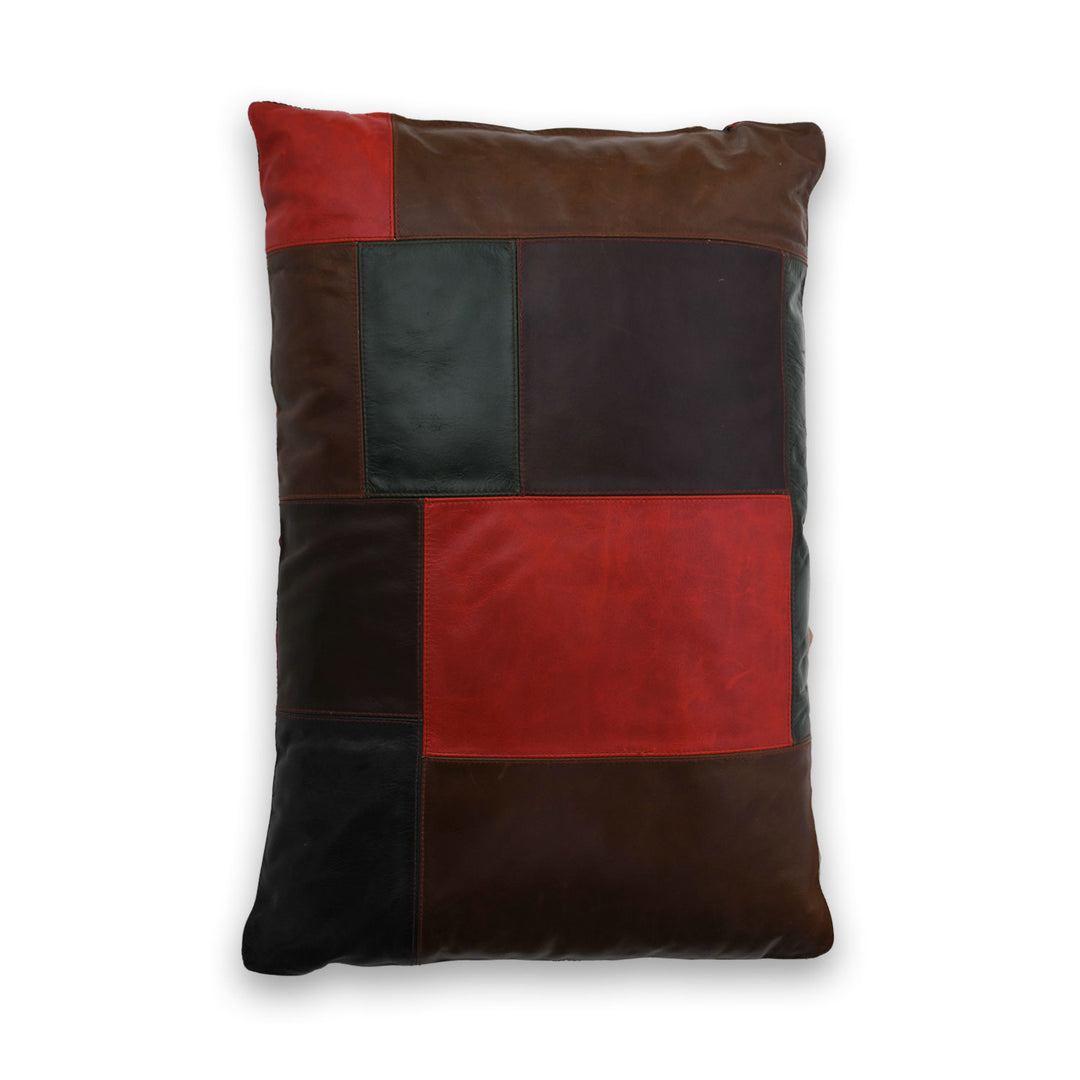 Patchwork pillow with brown, red, and black squares on a white background