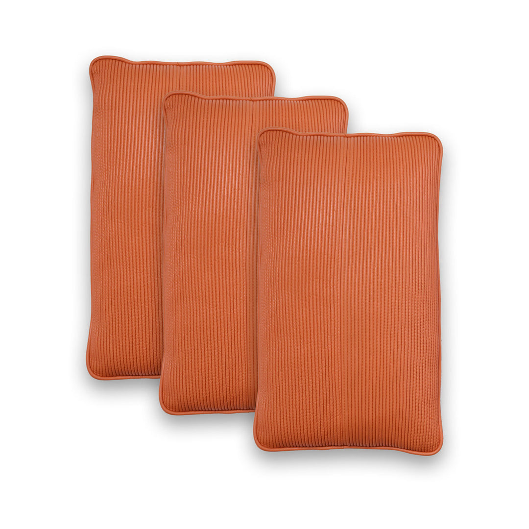Three orange rectangular cushions with a ribbed texture on a white background