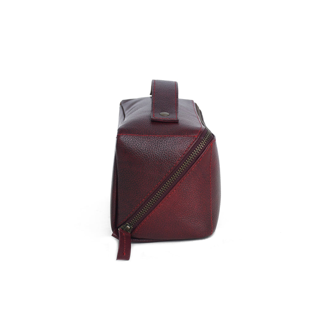 Brown leather Toiletry bag with a diagonal zipper on a white background
