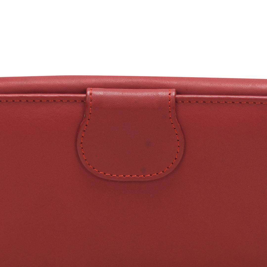 Close-up of a red leather product with a visible brand logo.