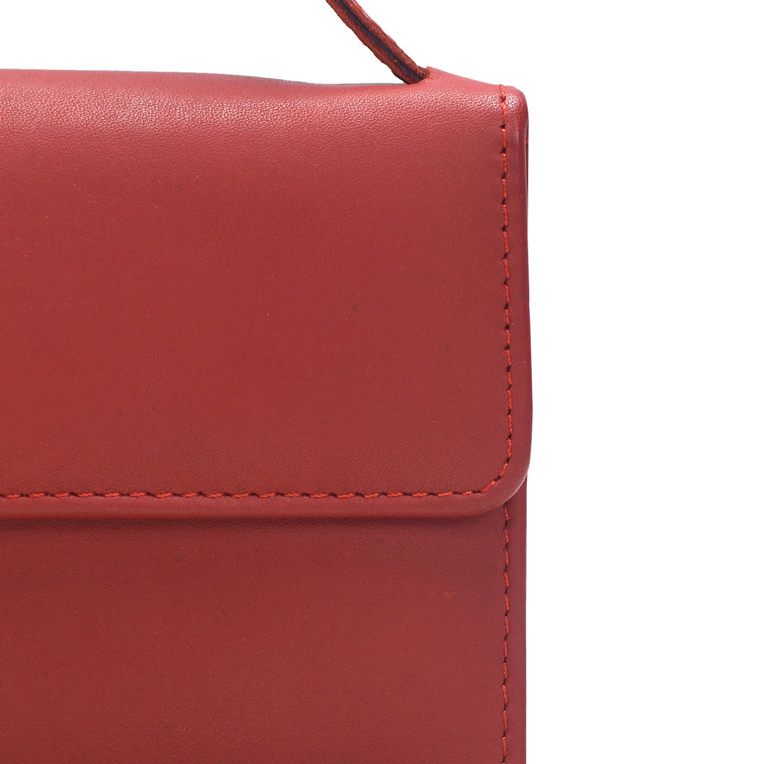 Close-up of a red leather handbag with a white background