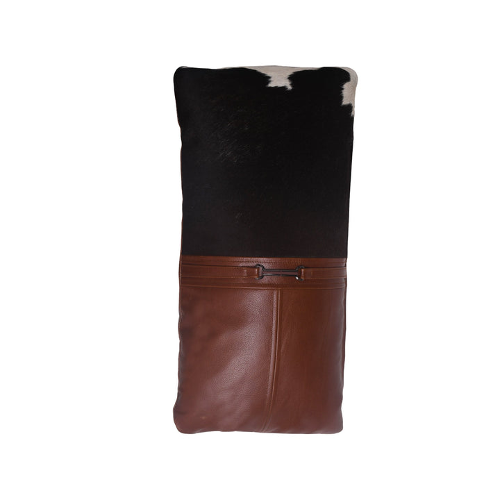 Brown leather and black cowhide patterned bag on a white background