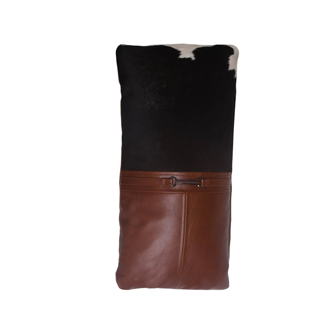 Brown leather and black cowhide patterned bag on a white background