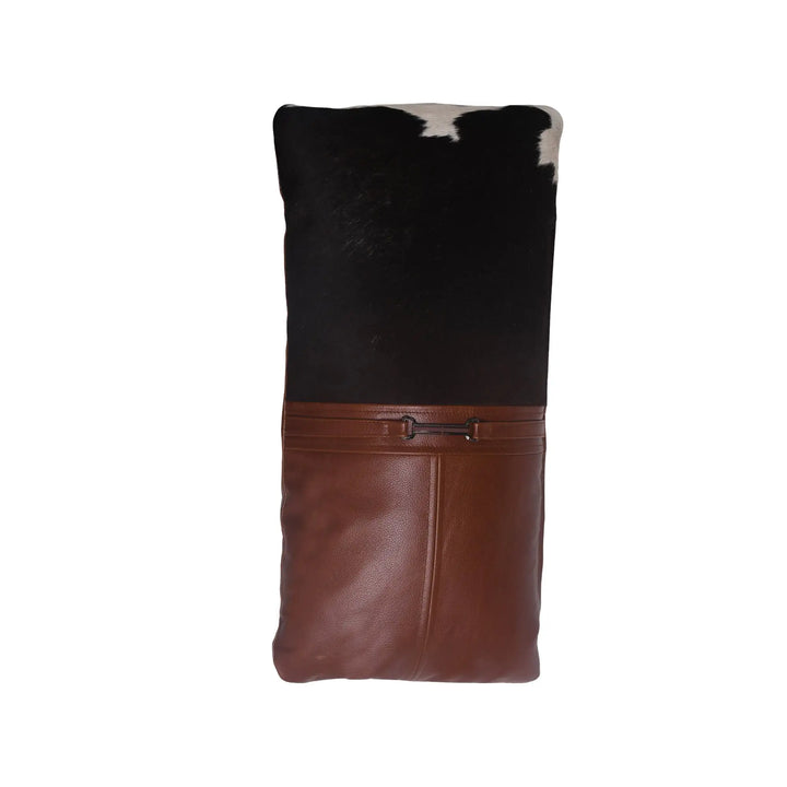 Brown leather and black cowhide patterned bag on a white background
