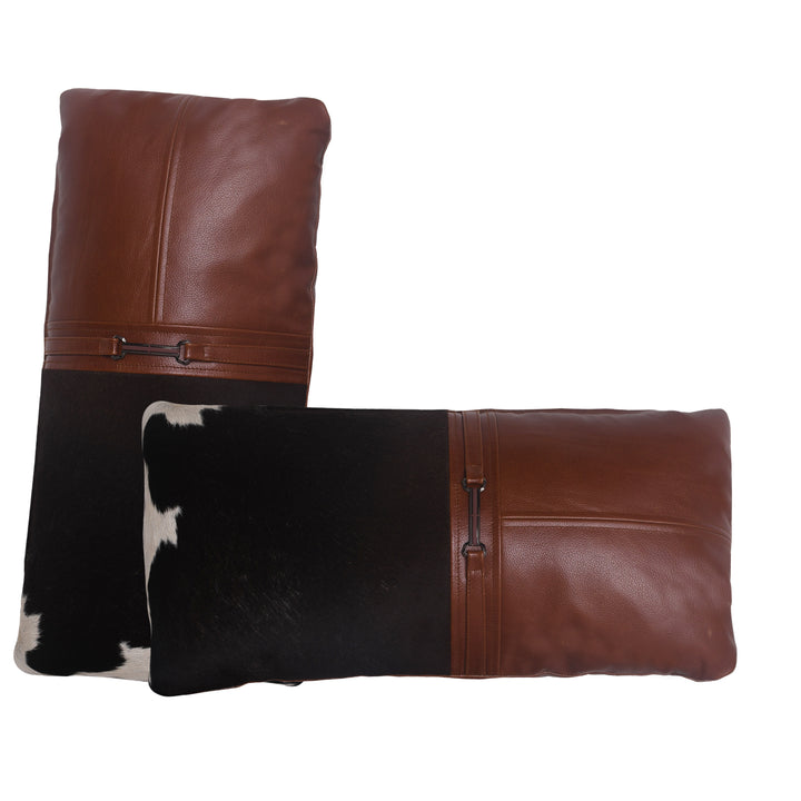Two decorative pillows with brown leather and cowhide pattern on a white background