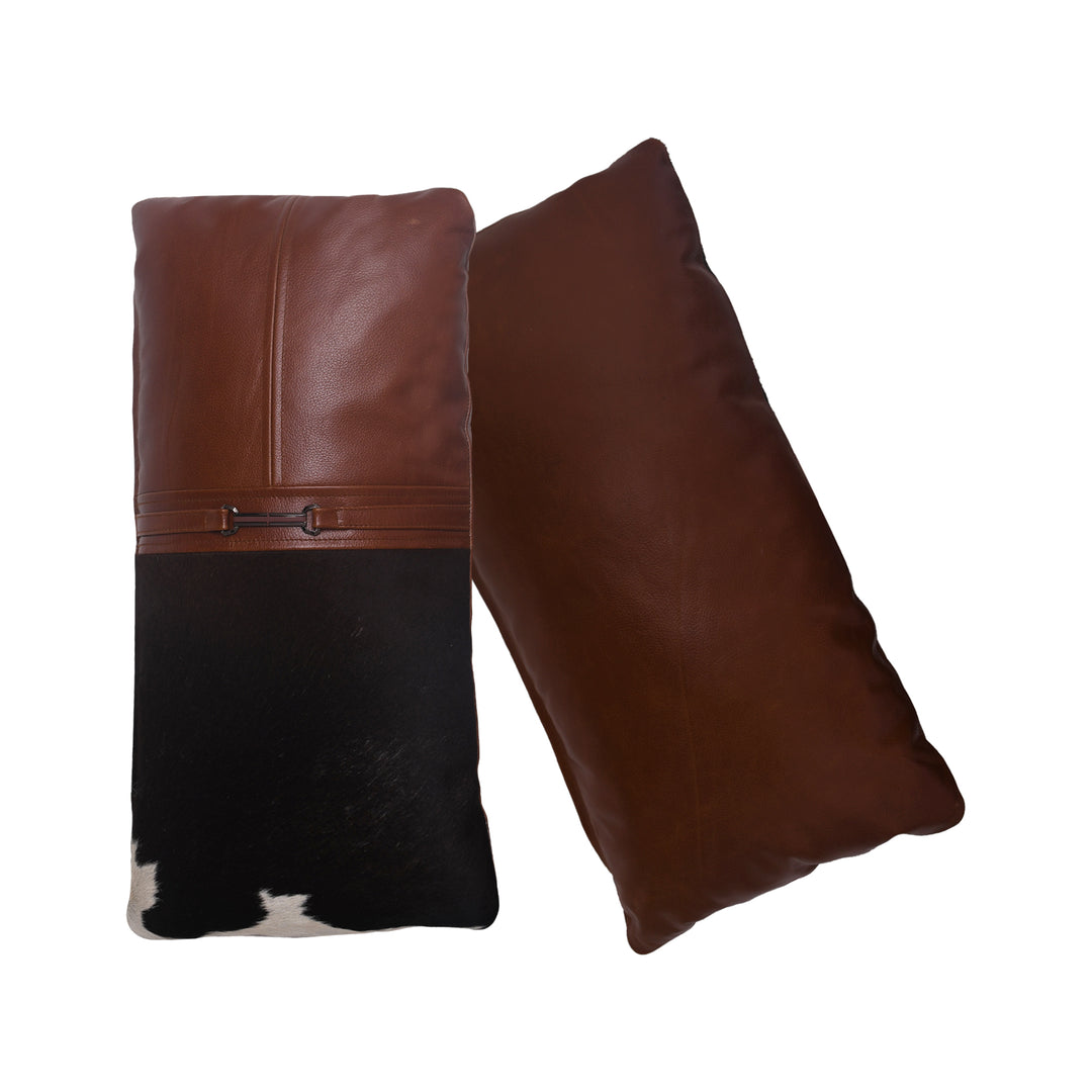 Brown leather pillow with a black and white cowhide pattern on a white background