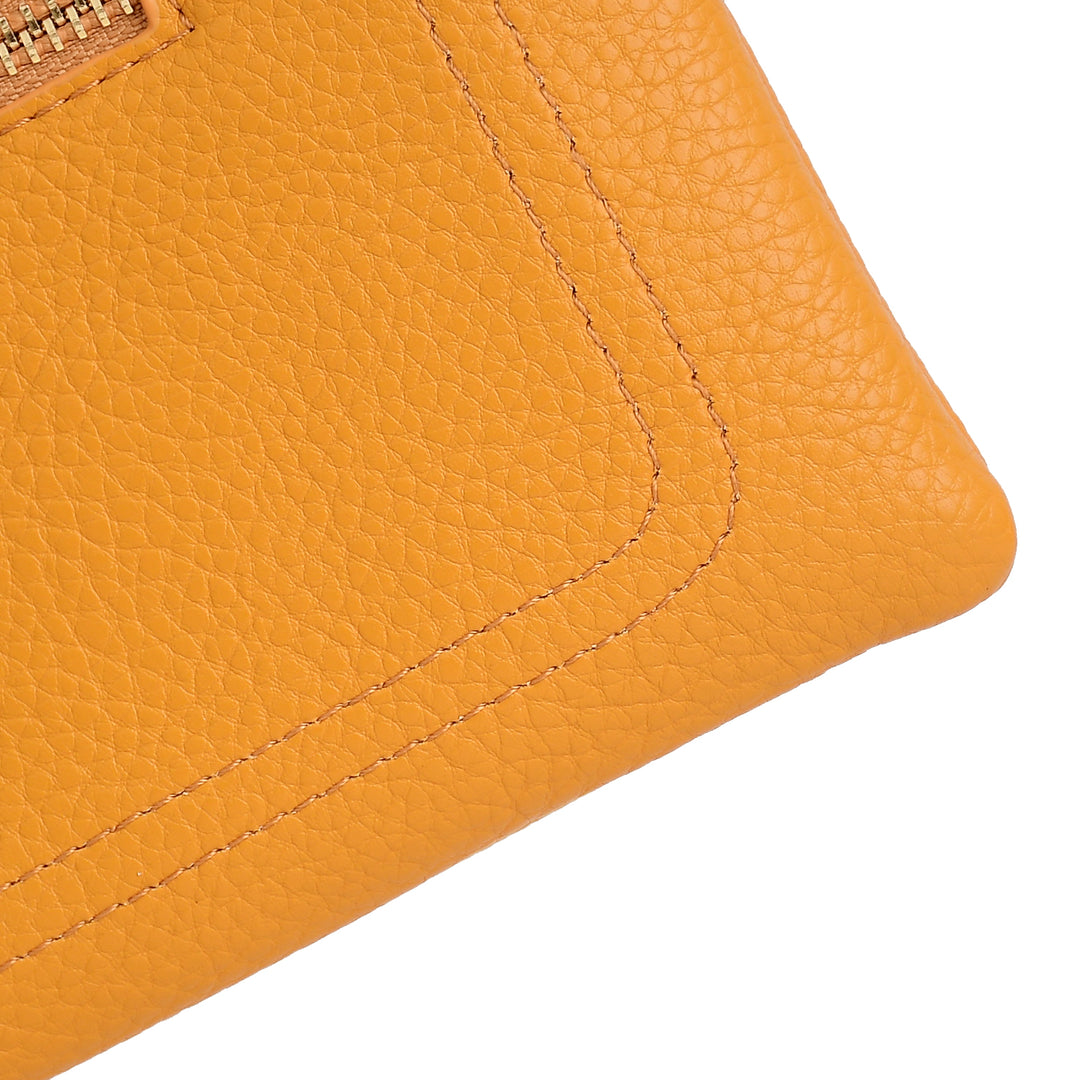 Close-up of a textured orange leather wallet corner on a white background