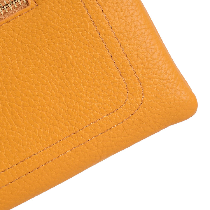 Close-up of a textured orange leather wallet corner on a white background