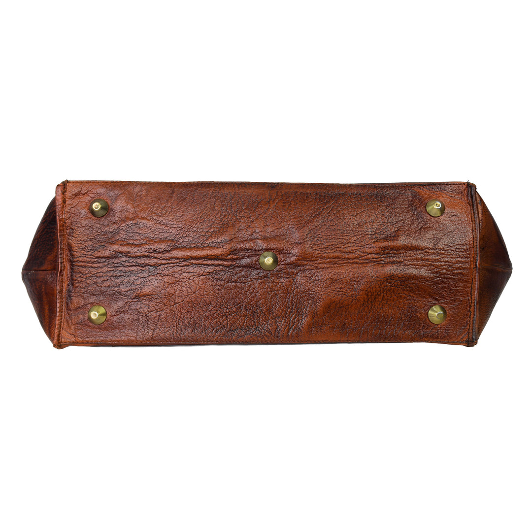 Brown leather bag with gold studs on a white background