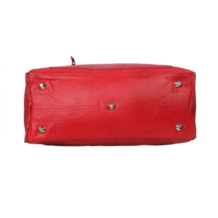 Red handbag with gold studs on a white background