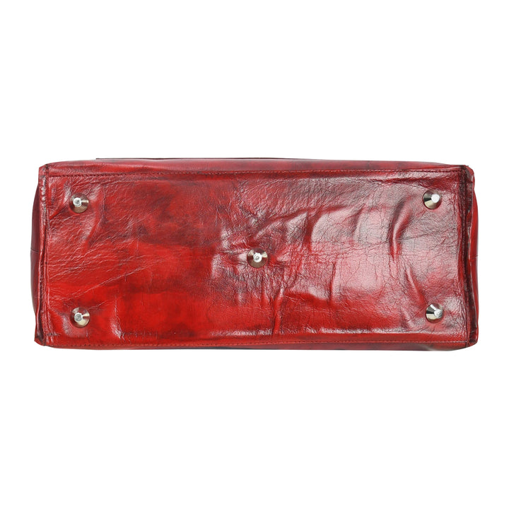 Red leather handbag with gold hardware on a white background