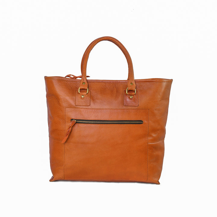 Brown leather tote bag with gold accents on a white background