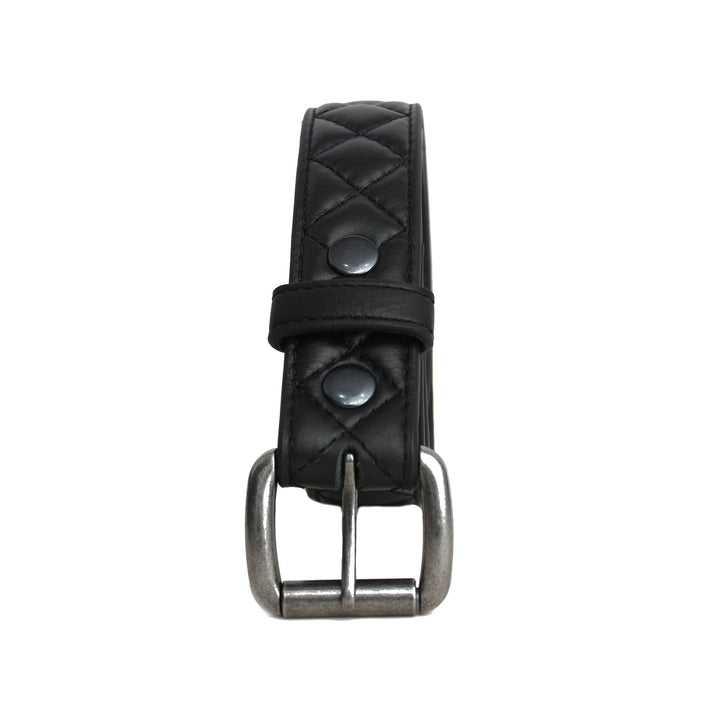 Black quilted leather belt with silver buckle on a white background