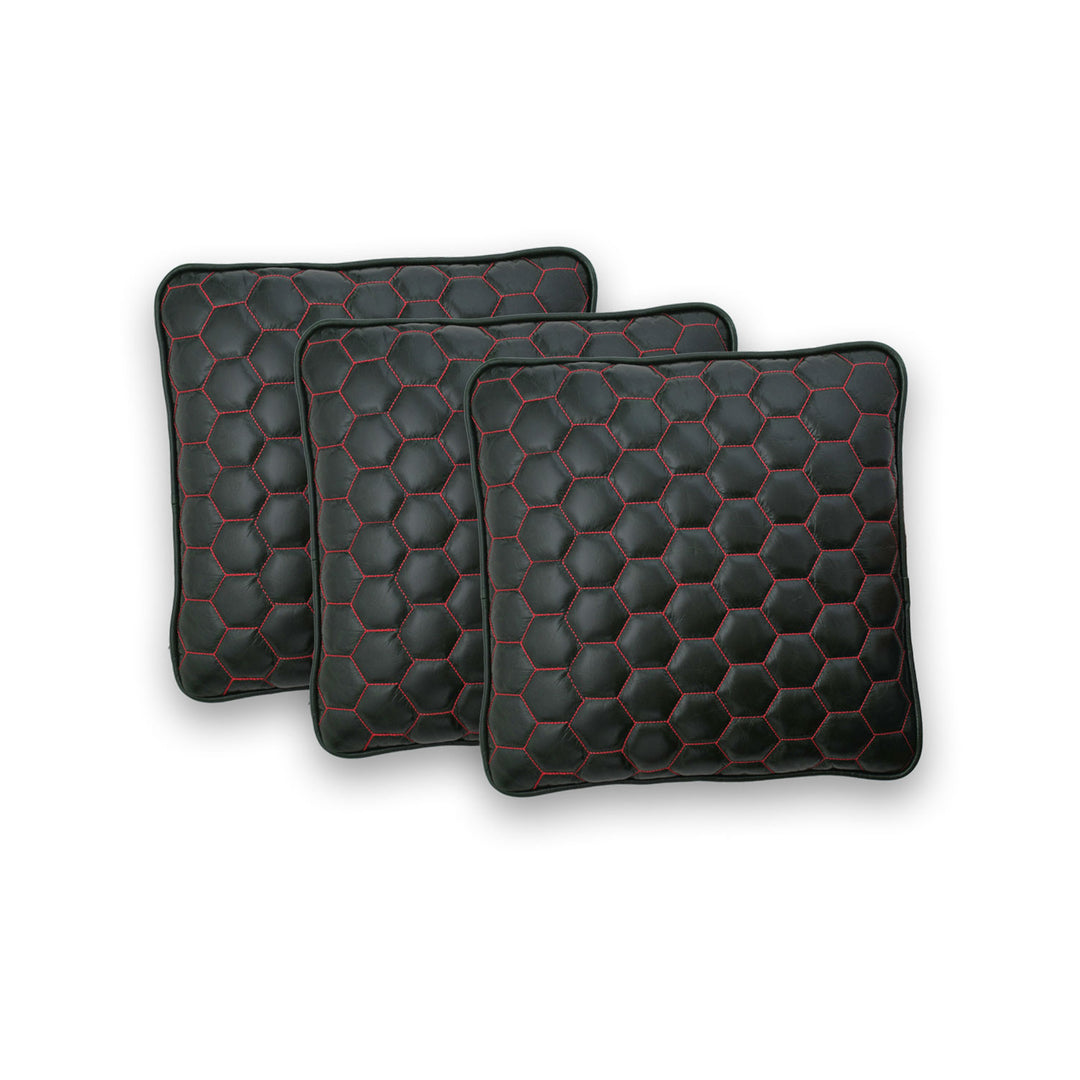 Three black hexagonal patterned pillows on a white background