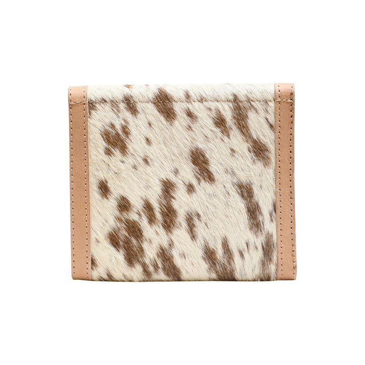 Trifold wallet with cow print design on a white background