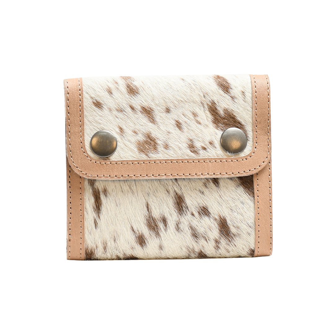 Small wallet with cowhide pattern and beige leather accents on a white background