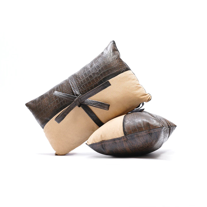 Two decorative pillows with a crocodile texture on a white background