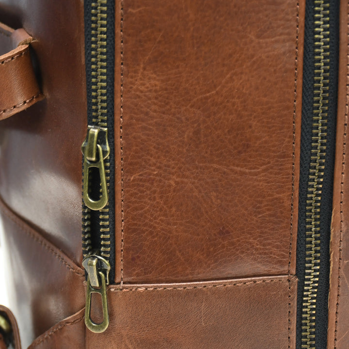 Close-up of a brown leather bag with gold zipper