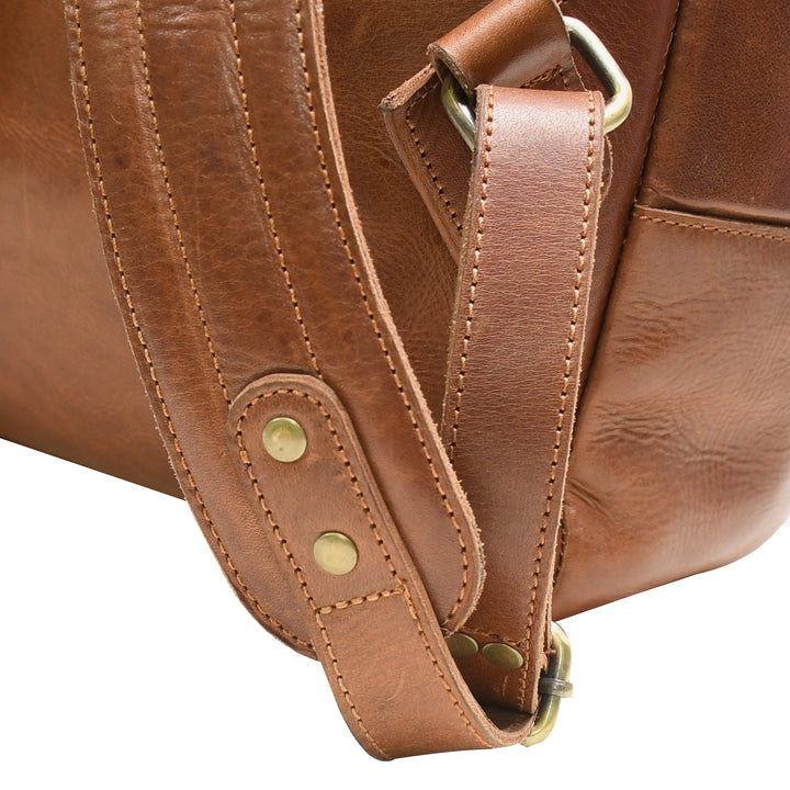 Close-up of a brown leather bag with visible stitching and gold hardware.