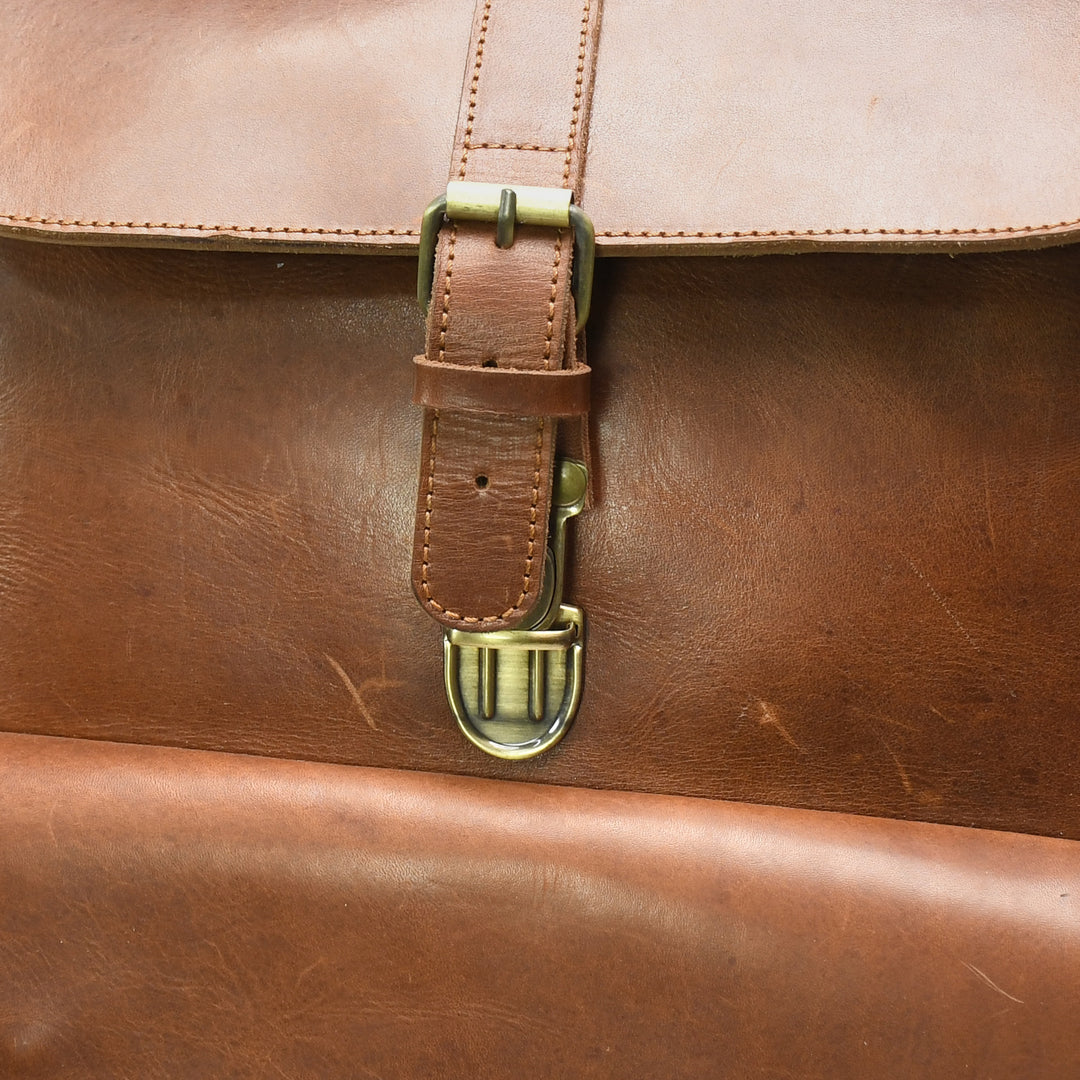 Close-up of a brown leather bag with a buckle detail