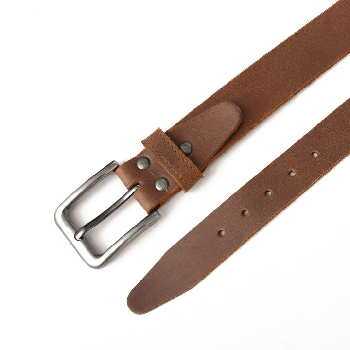Brown leather belt with a silver buckle on a white background