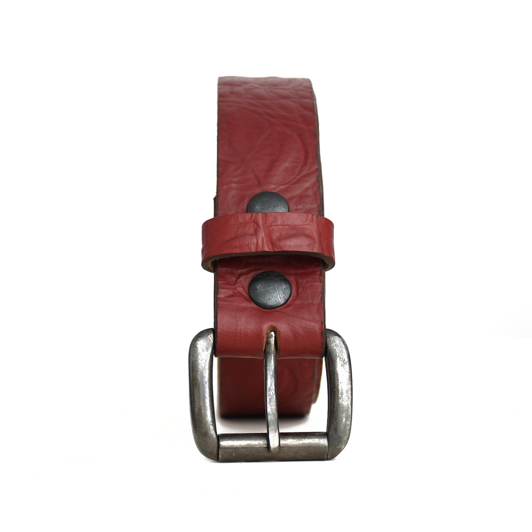 Red leather belt with silver buckle on a white background