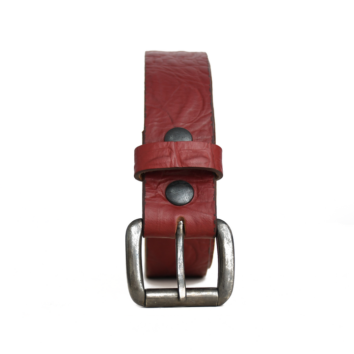 Red leather belt with silver buckle on a white background