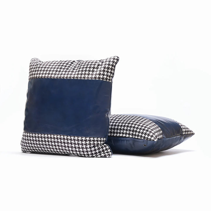 Two navy blue pillows with houndstooth pattern on a white background